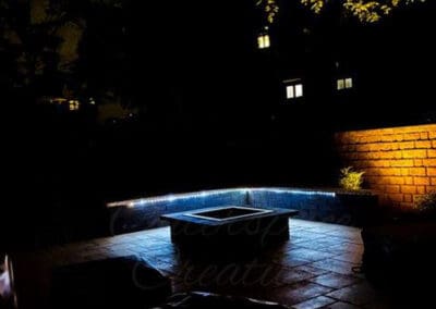 Night lit stone walkway and firepit